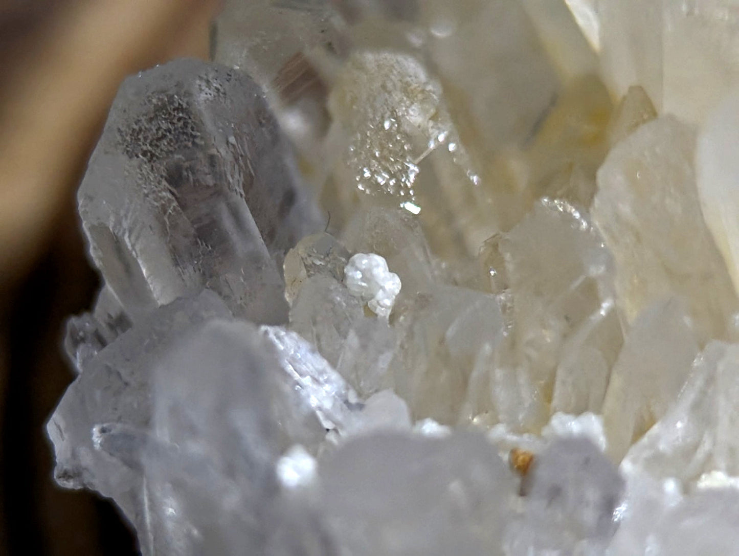 A translucent, crystalline mineral formation with clear and milky white facets.