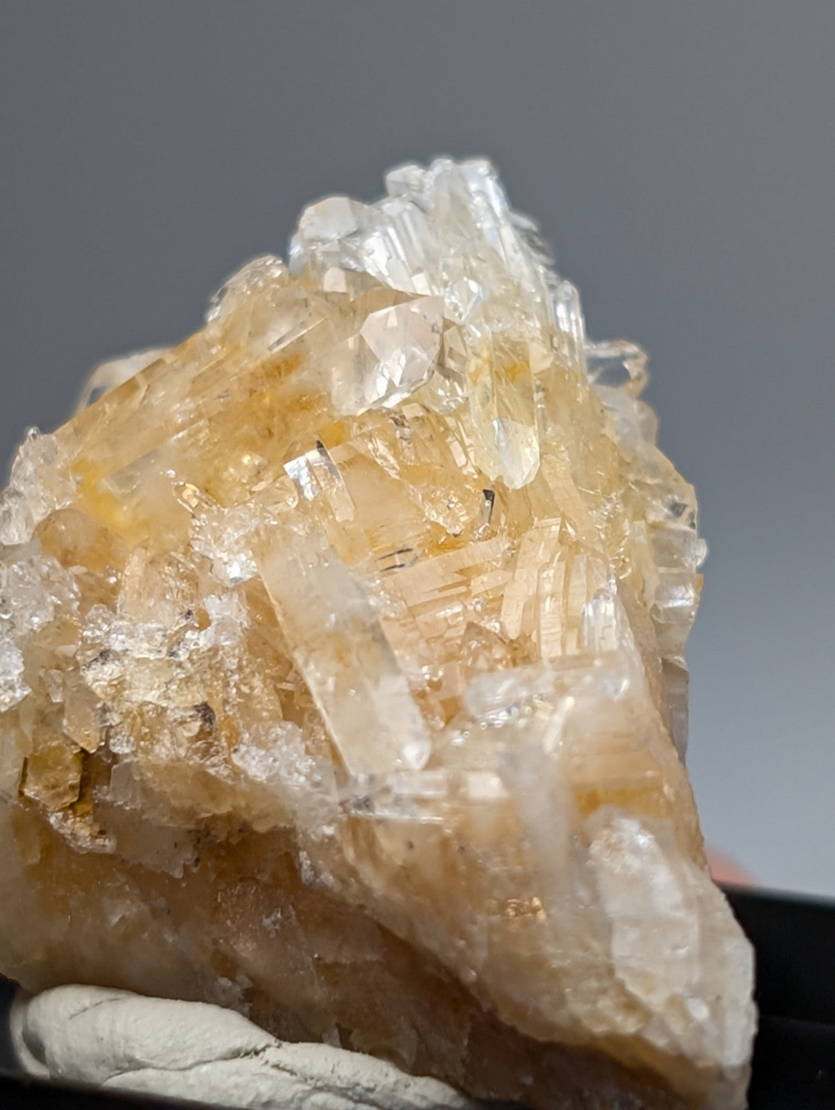 Solution quartz crystal cluster with translucent amber and clear faceted crystals mounted in photo case from Saline County Arkansas