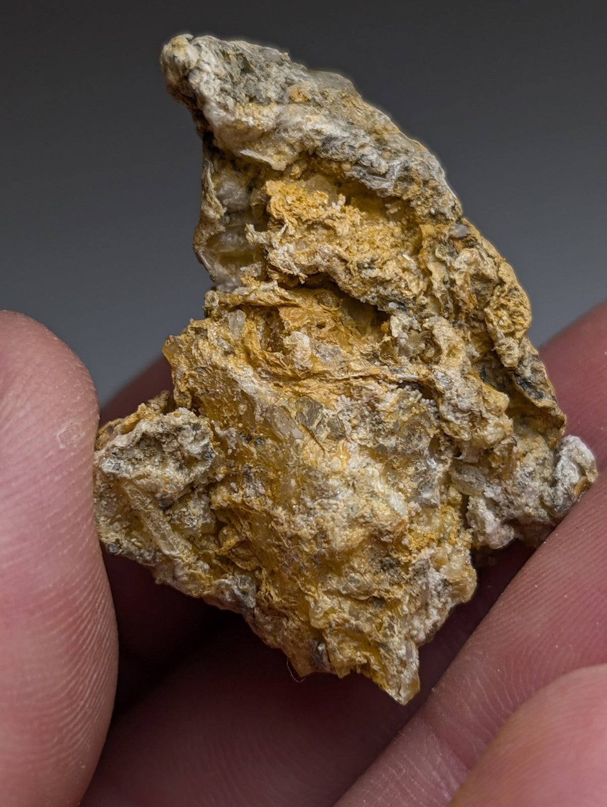 Solution quartz in rectorite mineral specimen with golden yellow and grayish white patches from Jeffrey Quarry Arkansas