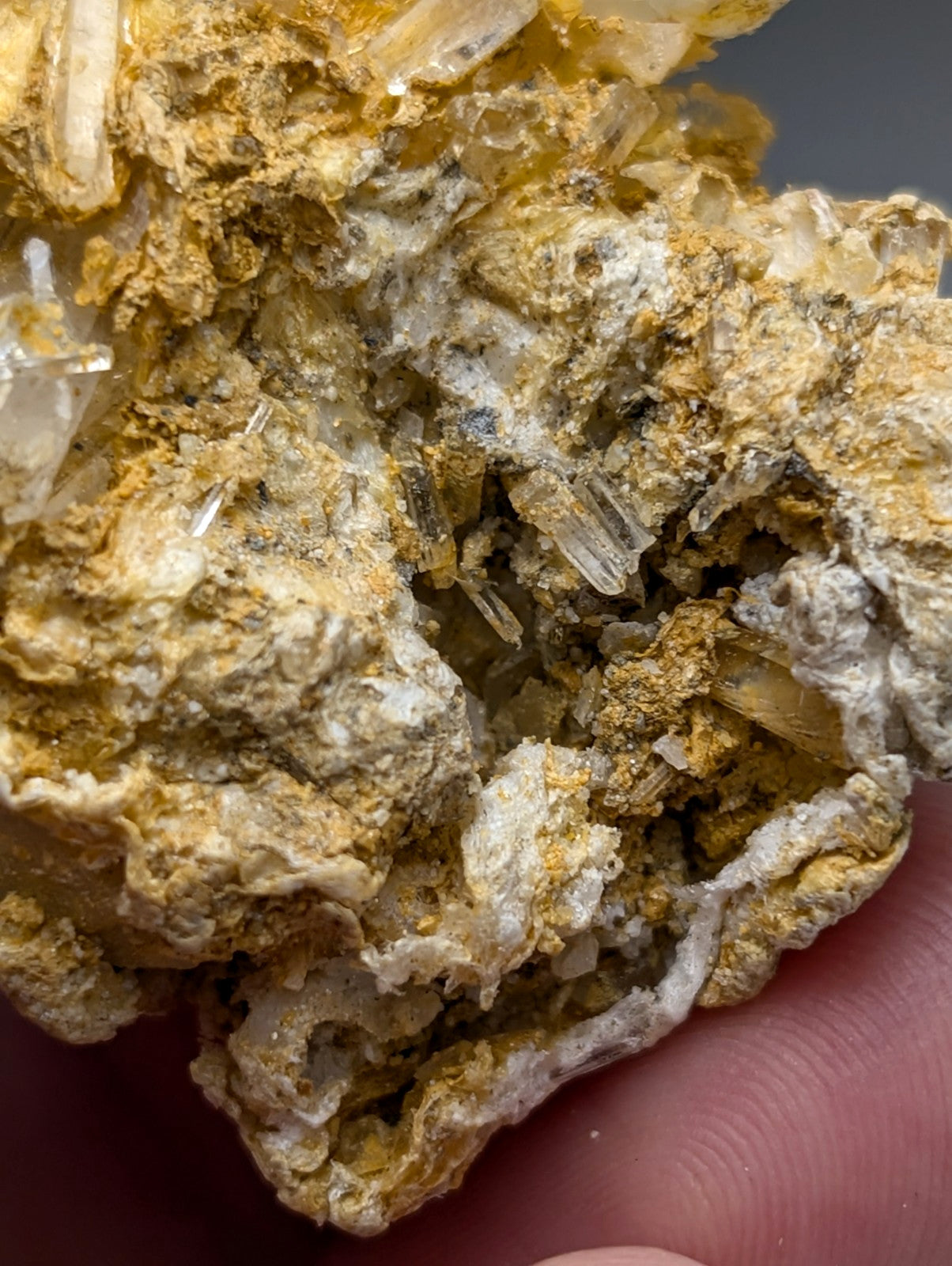 A cluster of translucent quartz crystals embedded in a golden-yellow rectorite matrix from jeffrey quarry arkansas