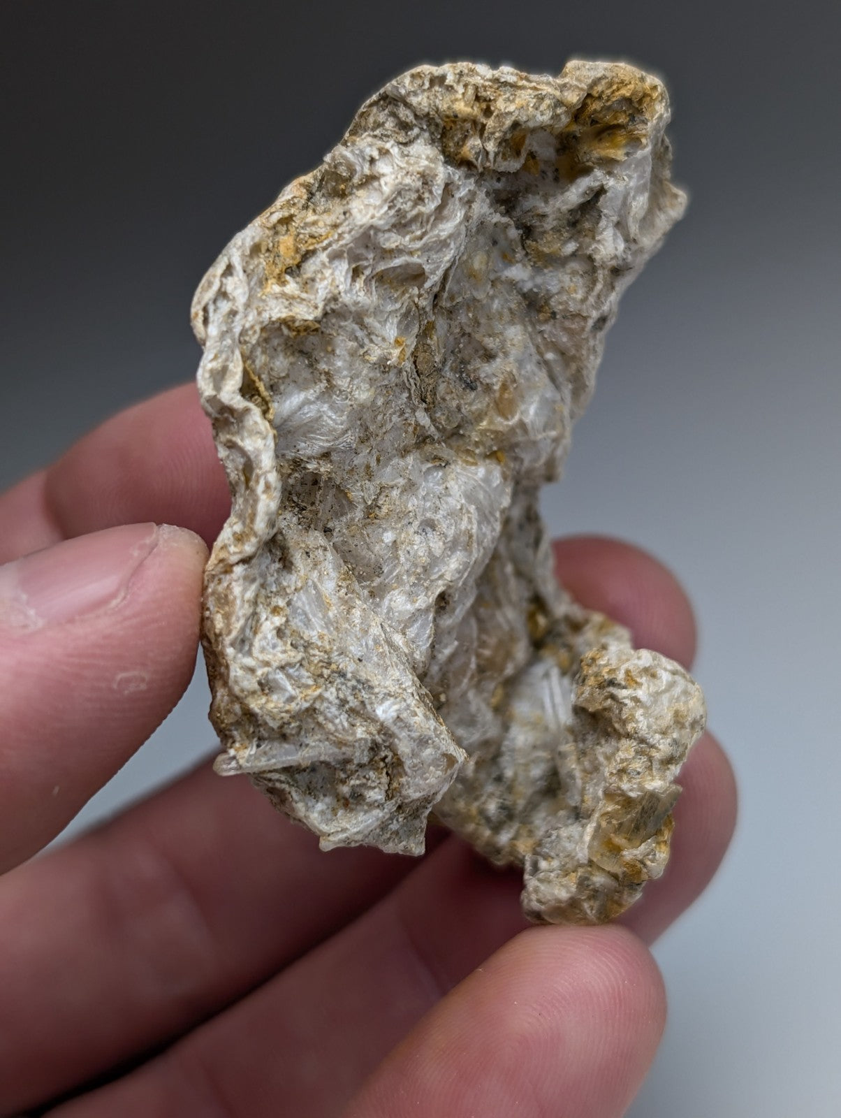 Solution quartz in rectorite with pale gray and yellowish translucent crystals on rocky matrix from jeffrey quarry arkansas