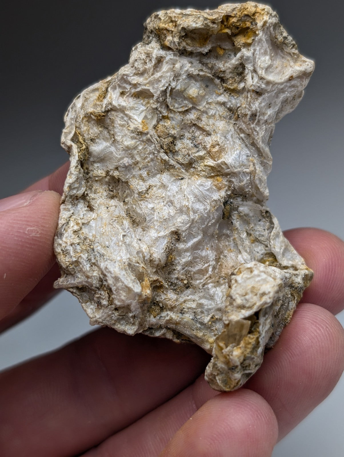 Solution quartz in rectorite unique set with white gray surface and yellowish gold patches from jeffrey quarry Arkansas