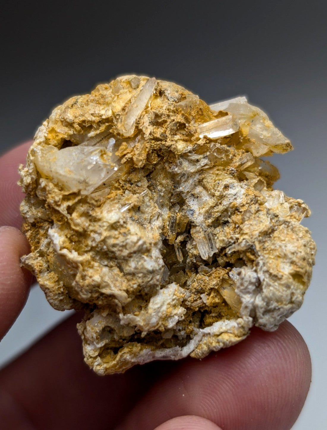 A cluster of translucent quartz crystals on golden-yellow rectorite from jeffrey quarry arkansas unique set