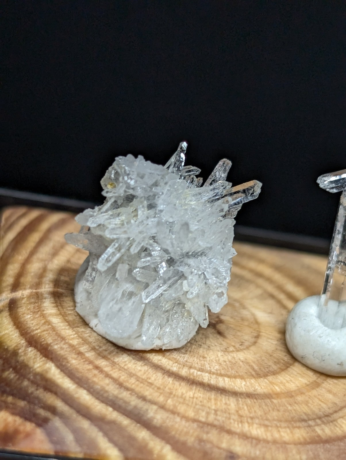 A clear quartz crystal cluster with sharp, translucent points and a rough, natural base.