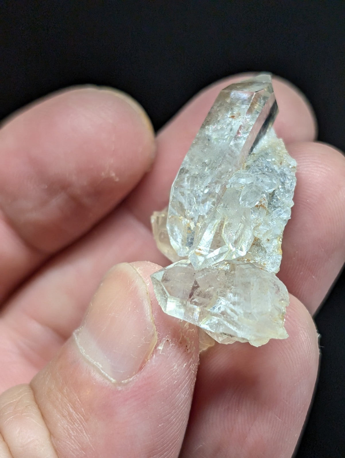 A translucent, pale quartz crystal cluster with jagged edges and a slightly cloudy appearance.