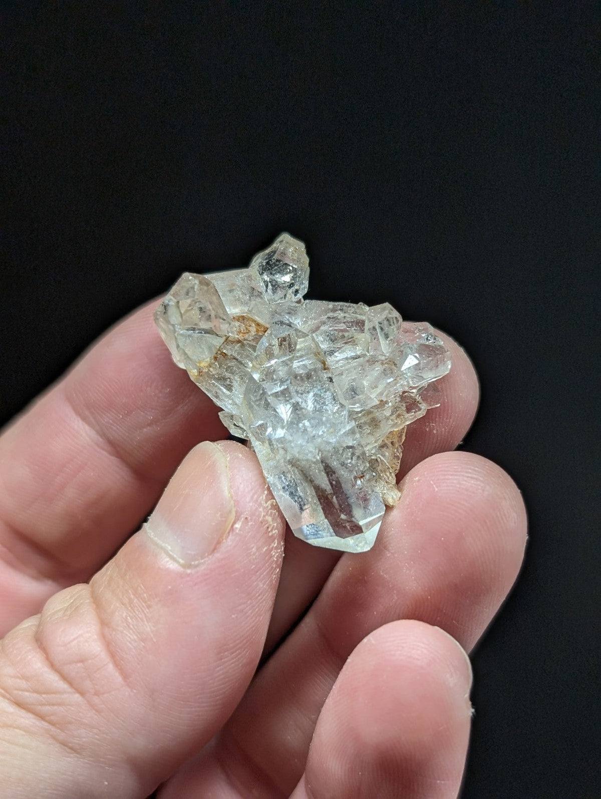 A translucent, faceted quartz crystal cluster with a pale yellowish tint and visible internal inclusions.