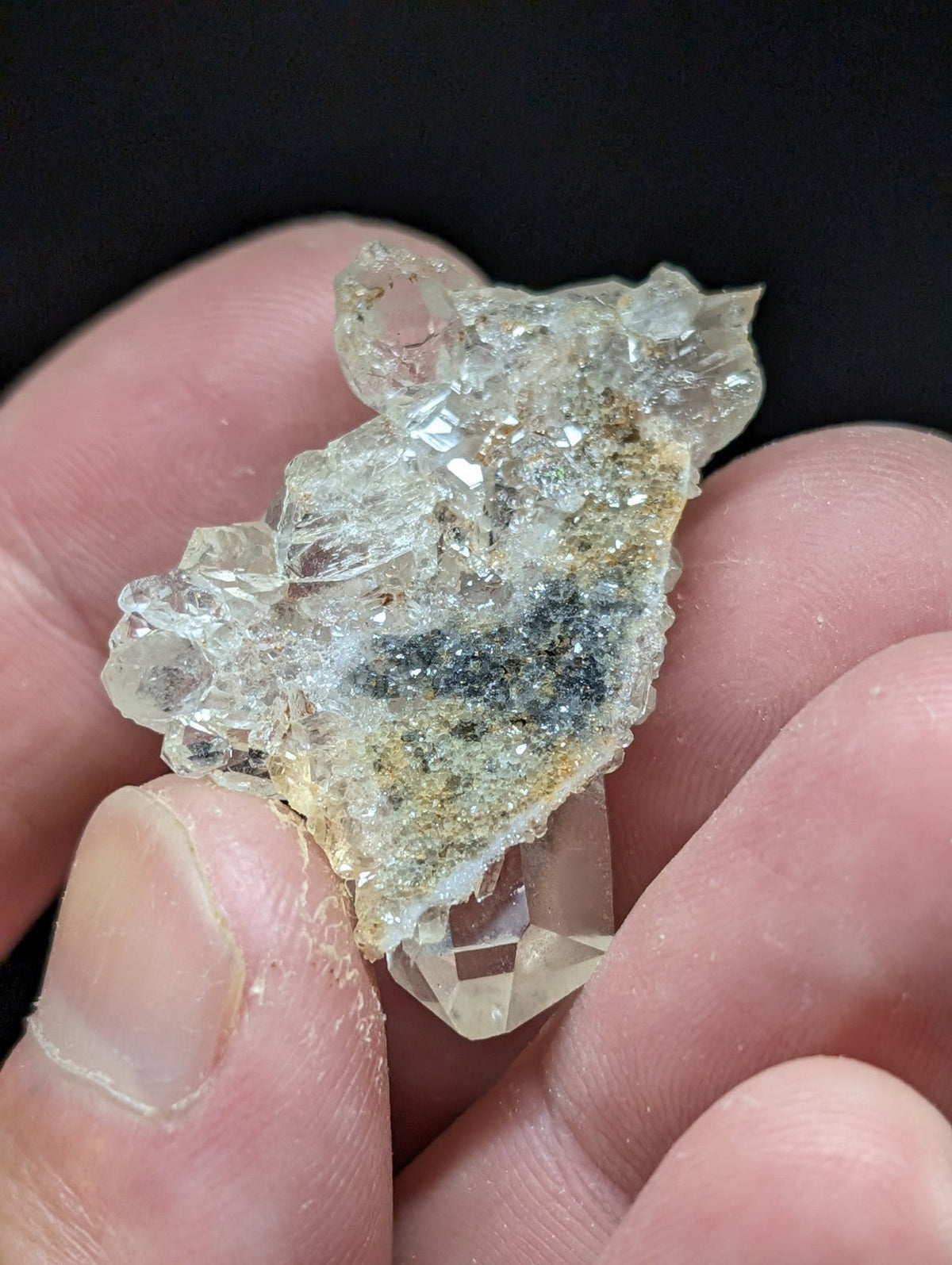 A translucent, crystalline quartz cluster with a rough, jagged surface and subtle greenish-yellow mineral inclusions.