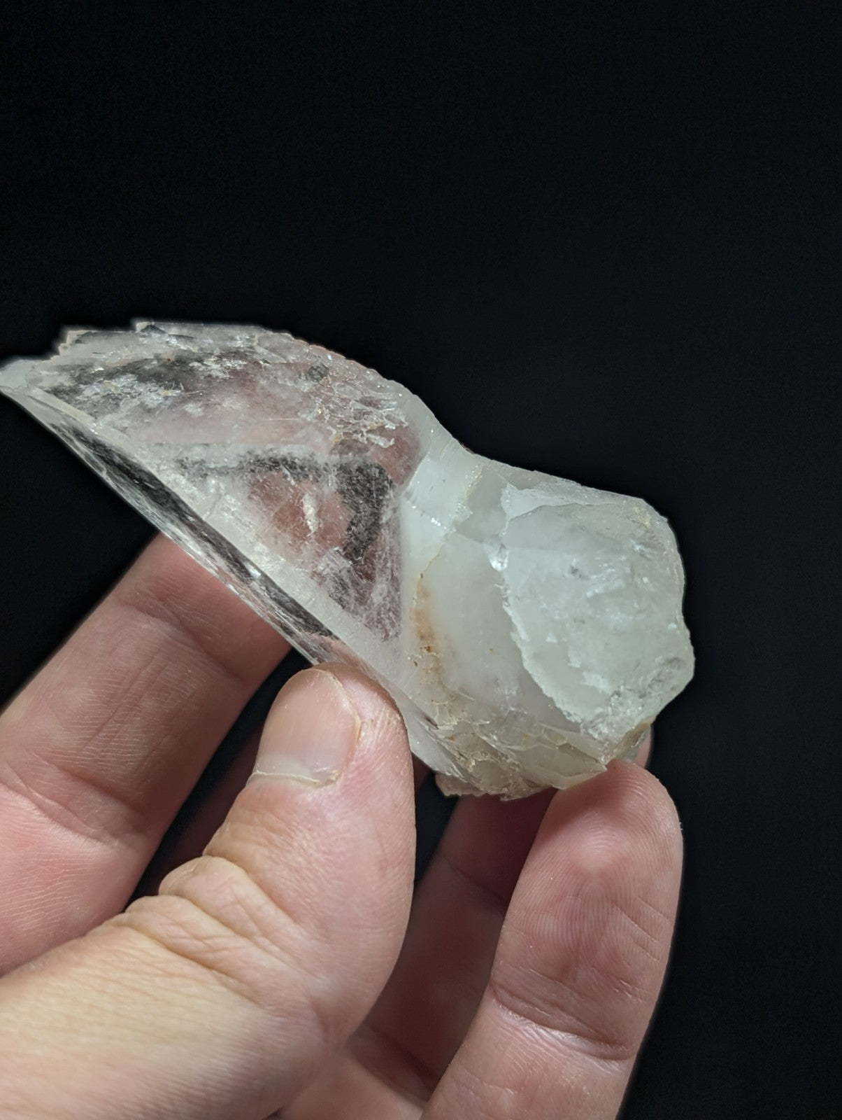 A translucent, irregularly shaped mineral specimen with a milky white hue and visible internal inclusions.