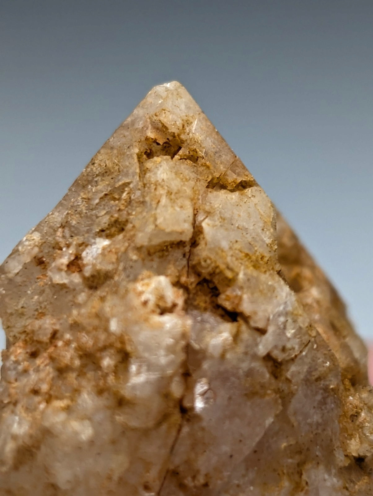 Unique dissolution quartz crystal point with translucent golden hue and internal fractures from garland county arkansas