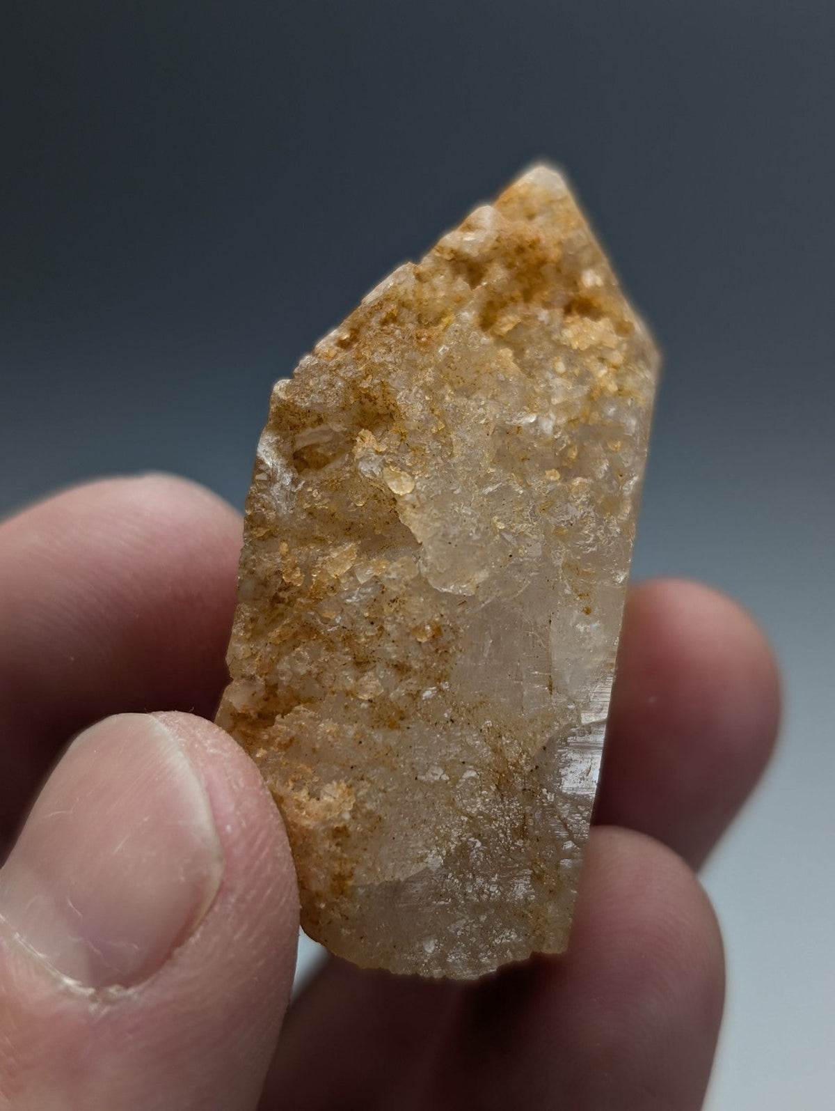 Unique dissolution quartz crystal point with translucent golden yellow color and visible internal inclusions from arkansas