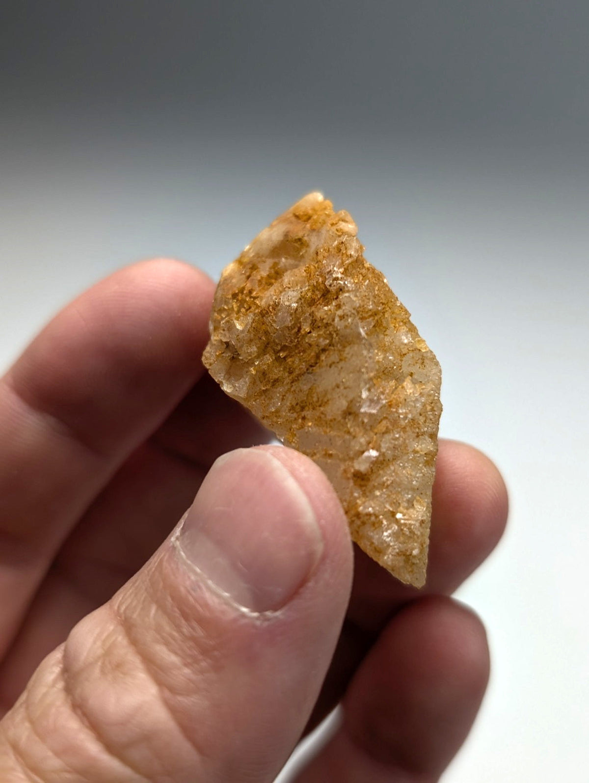 Unique dissolution quartz crystal point showing translucent golden yellow rough surface with mineral inclusions from arkansas