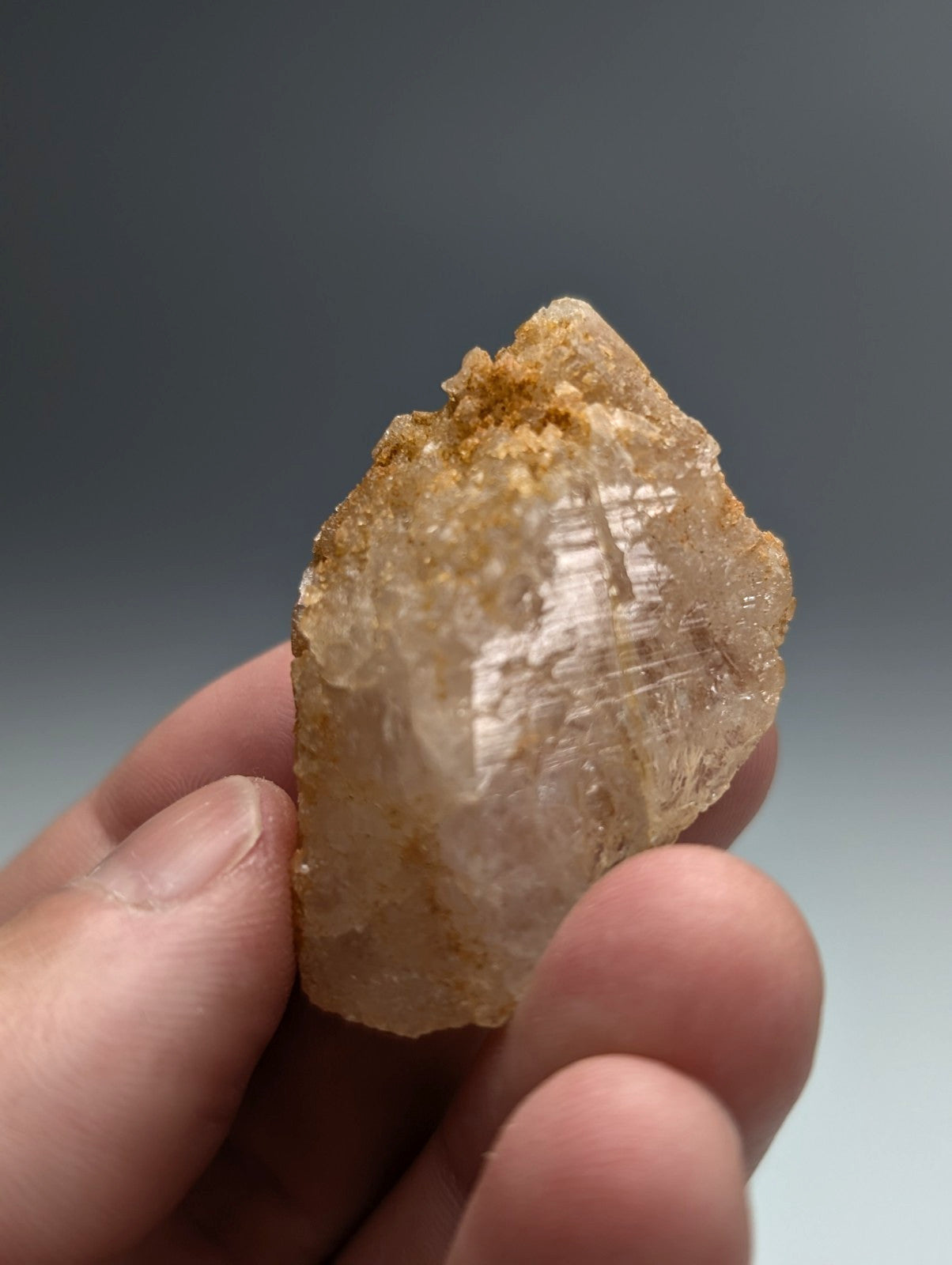 Unique dissolution quartz crystal point amber hued translucent rough natural surface from Garland County Arkansas