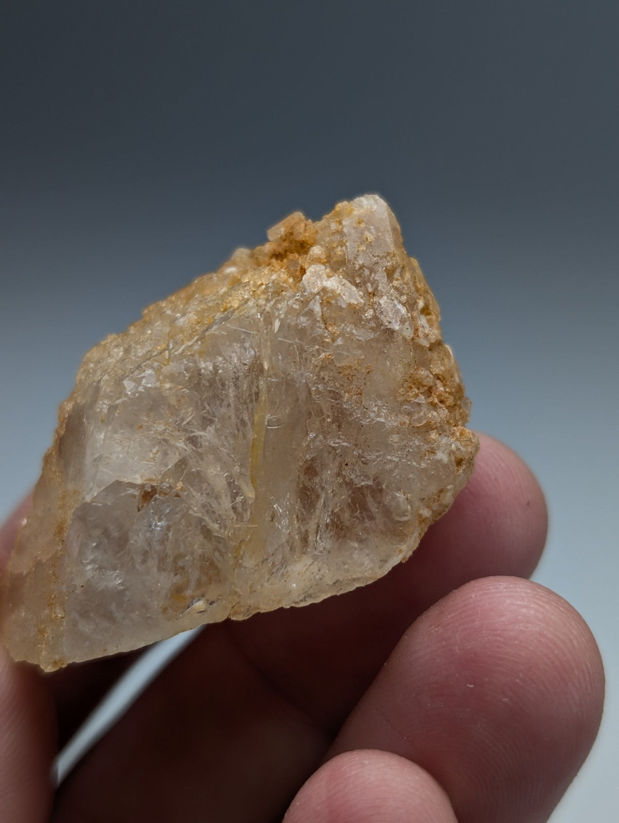 Unique dissolution quartz crystal point with a rough golden translucent surface and visible internal structures from arkansas