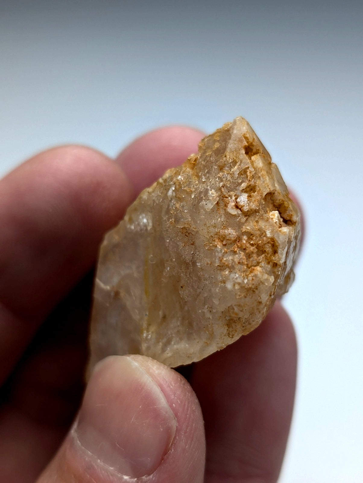 Unique dissolution quartz crystal point with translucent amber hue and rough surface from garland county arkansas