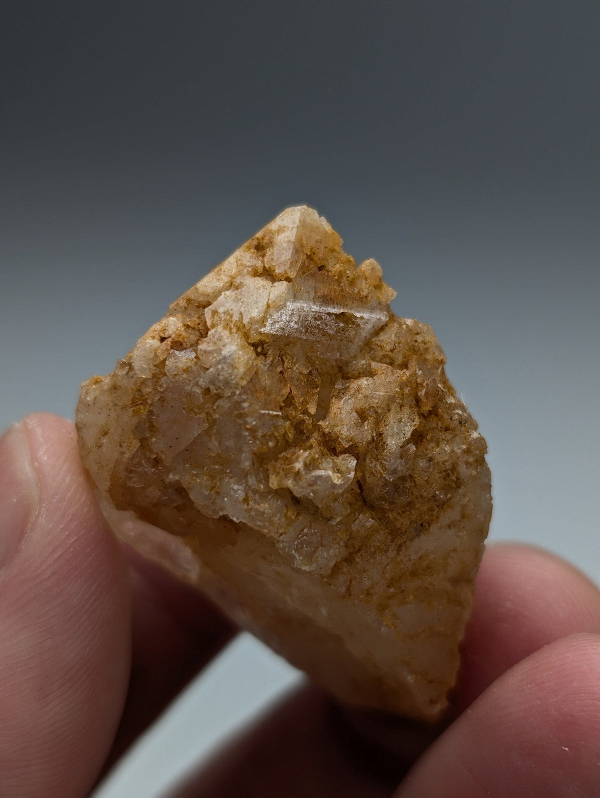 Unique dissolution quartz crystal point with translucent golden-yellow crystalline facets and earthy matrix from arkansas
