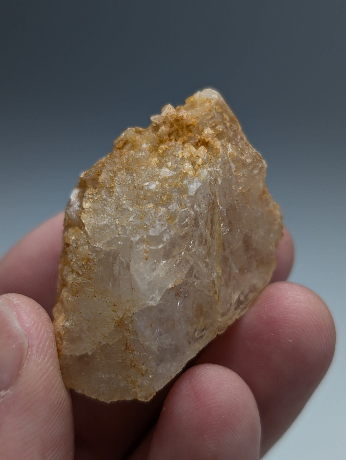 Unique dissolution quartz crystal point with translucent golden hue and jagged surface from garland county arkansas