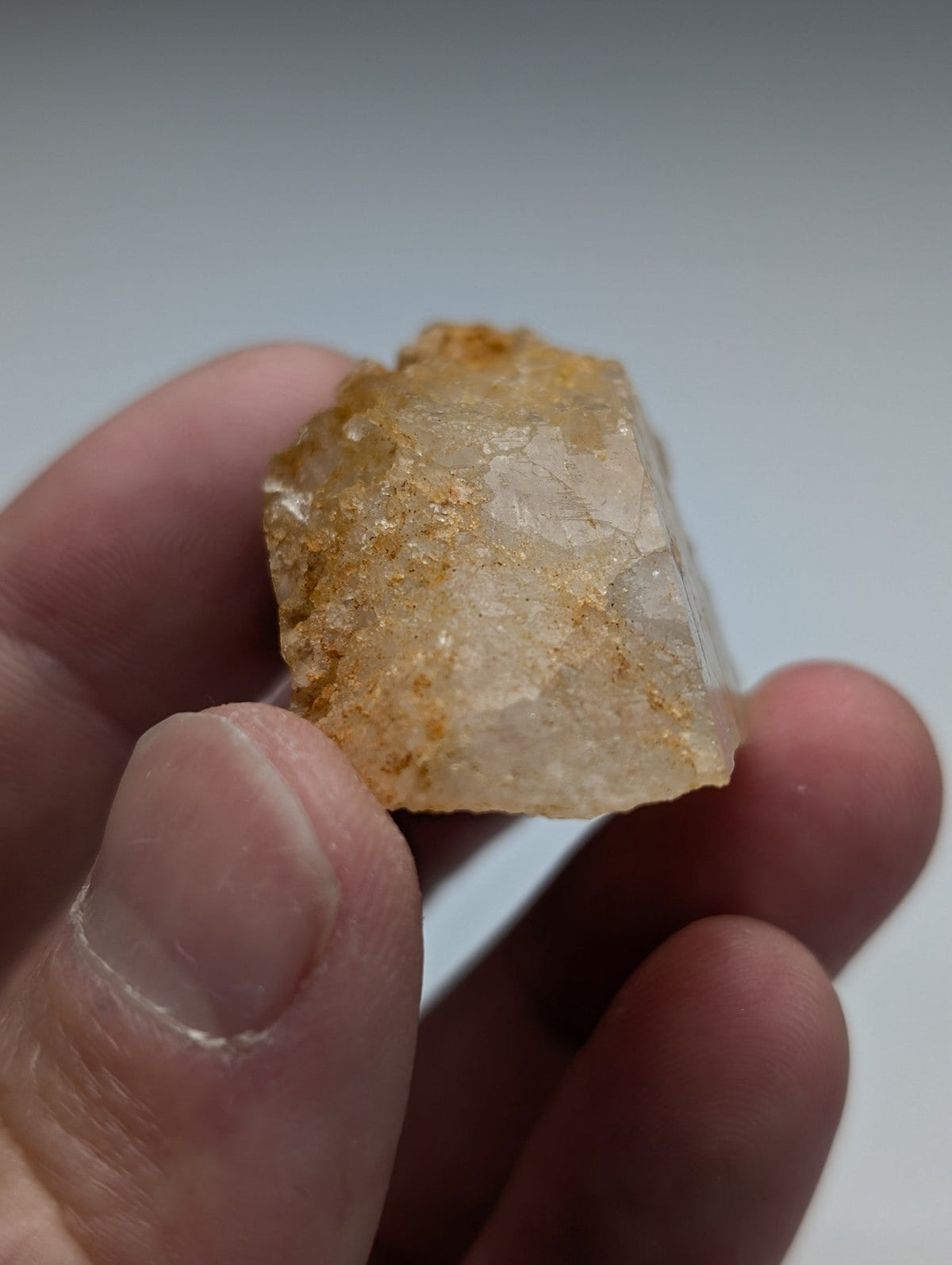 Unique dissolution quartz crystal point with translucent pale yellow surface and golden mineral inclusions from Arkansas