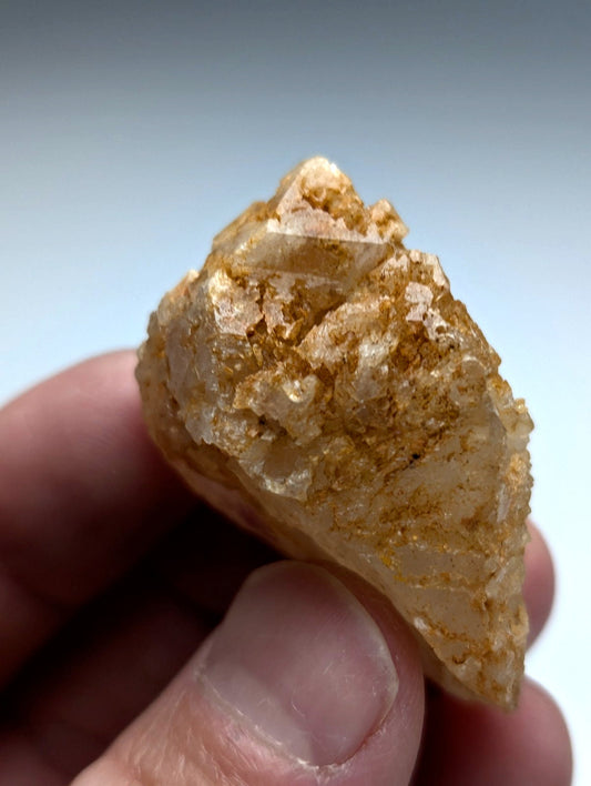 Unique dissolution quartz crystal point with translucent golden yellow color and metallic flecks from Garland County Arkansas