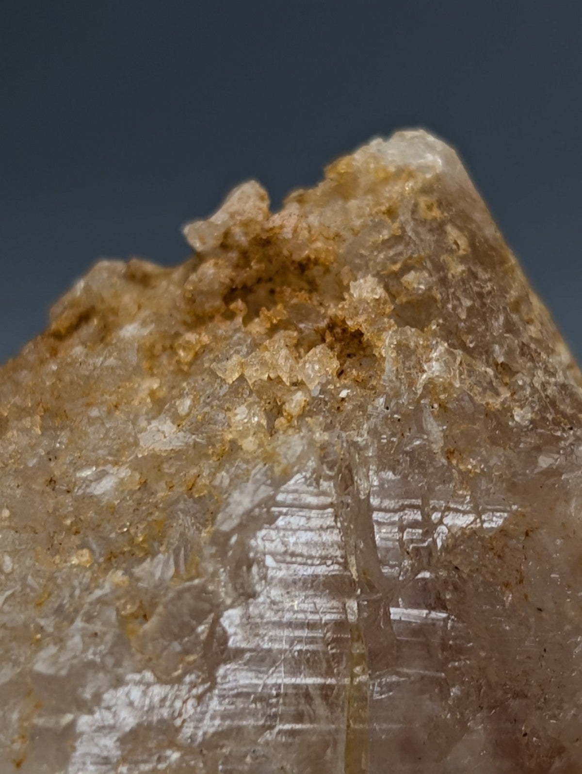 Unique dissolution quartz crystal point with translucent golden hues and jagged striations from Garland County Arkansas