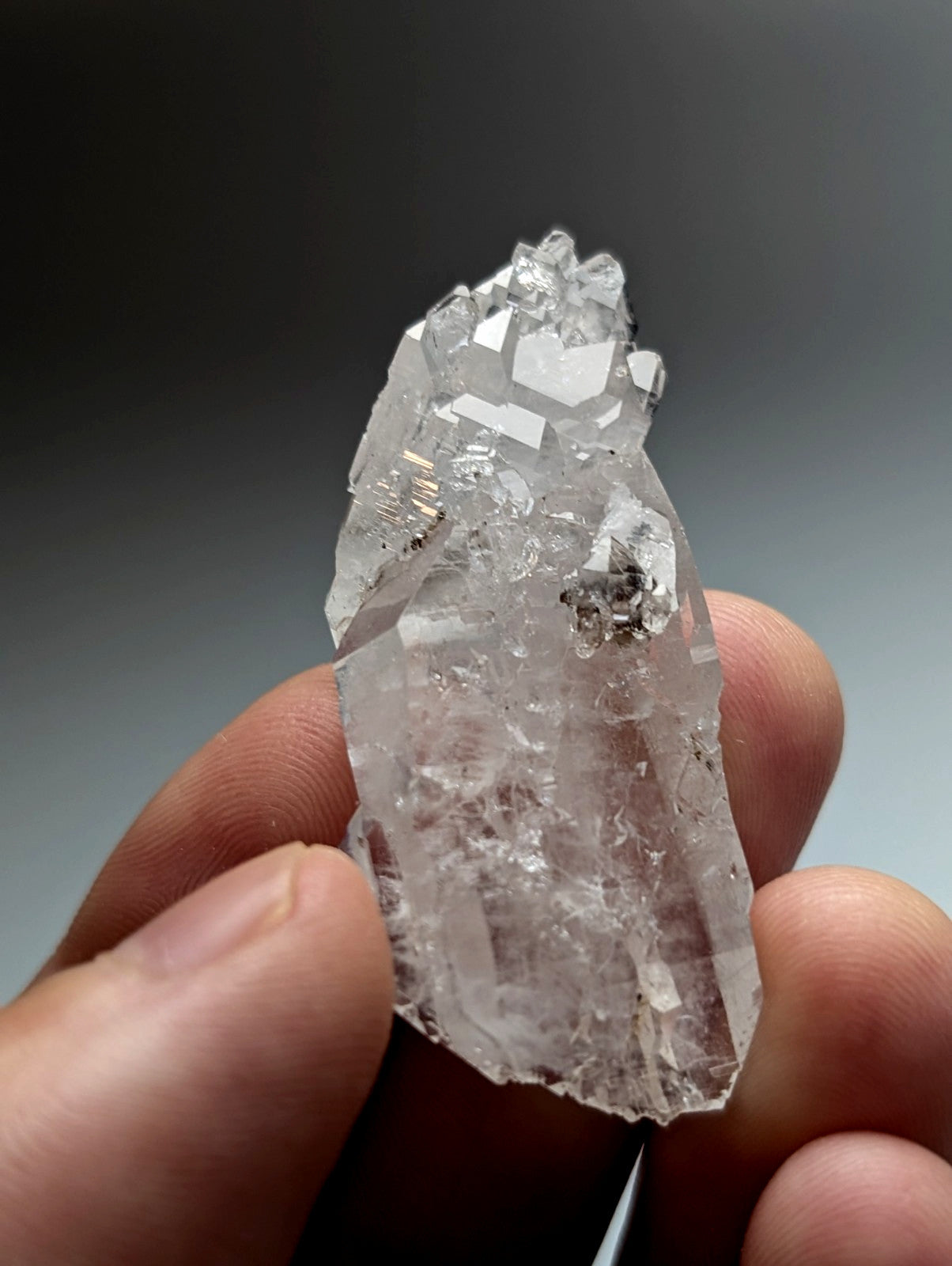 Unique double terminated floater quartz crystal cluster with clear translucent facets and dark mineral inclusions from Arkansas