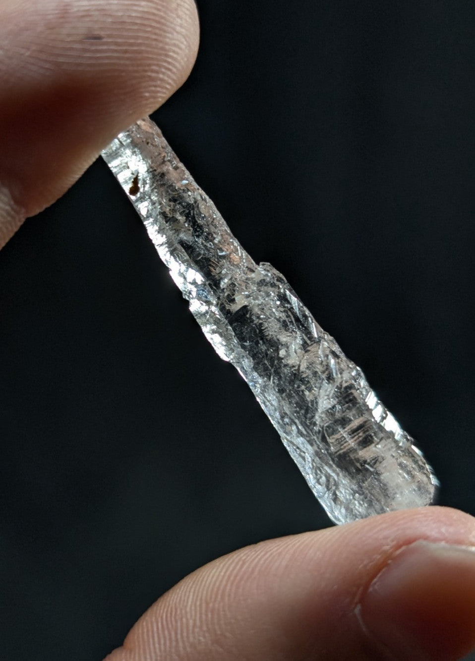 A clear, translucent quartz crystal with natural facets and internal inclusions.