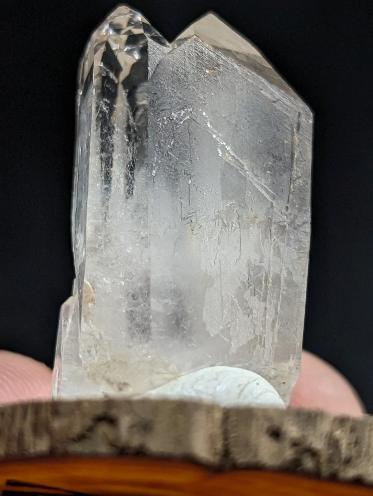 A translucent, clear quartz crystal with natural facets and internal inclusions.