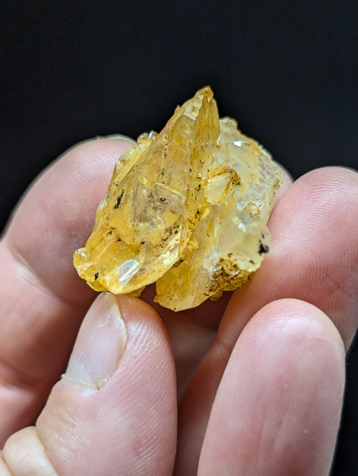 A translucent yellow crystal cluster with jagged, faceted edges and subtle internal inclusions.