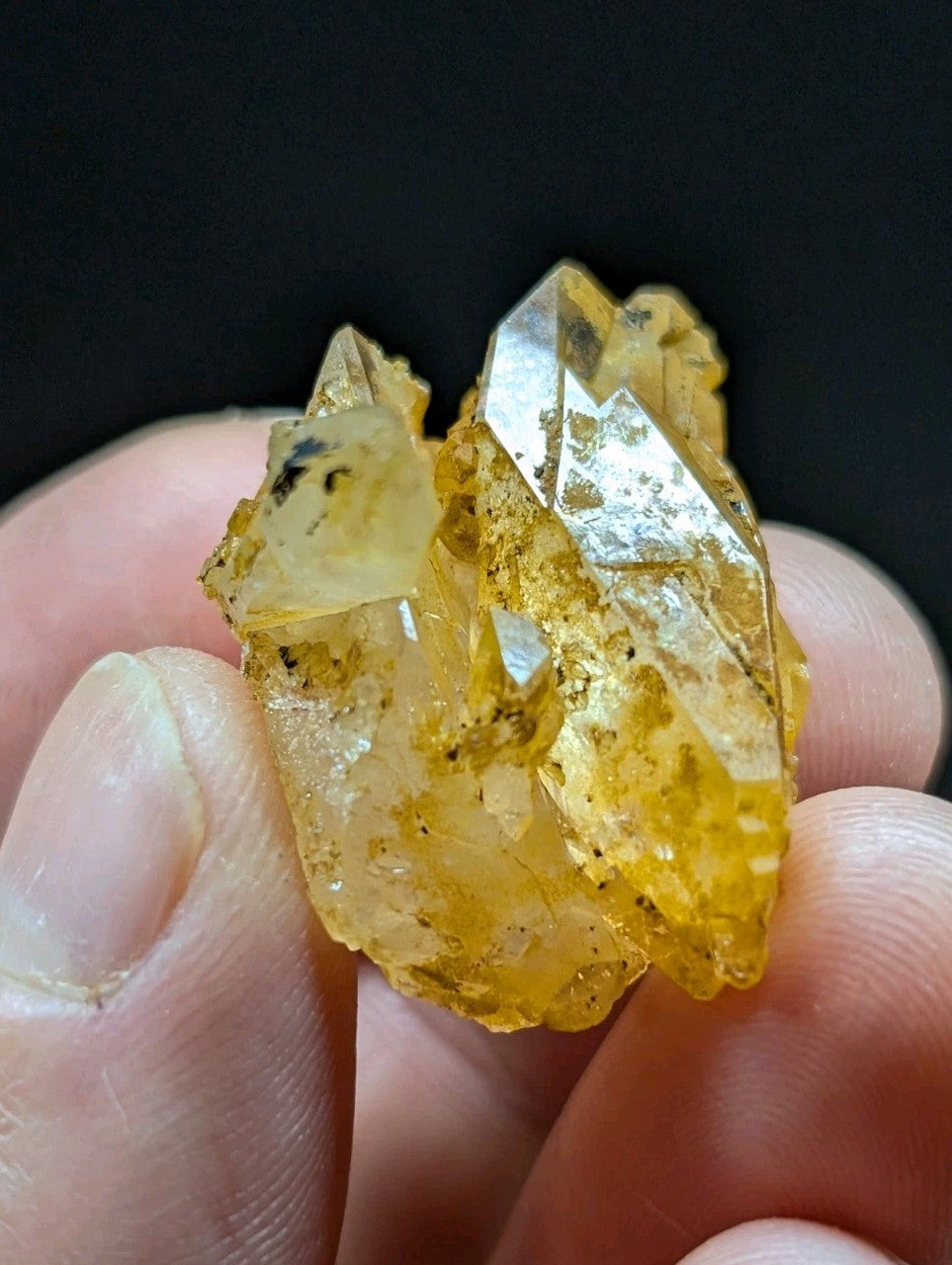 A cluster of translucent yellow crystals with sharp, faceted edges and subtle internal inclusions.