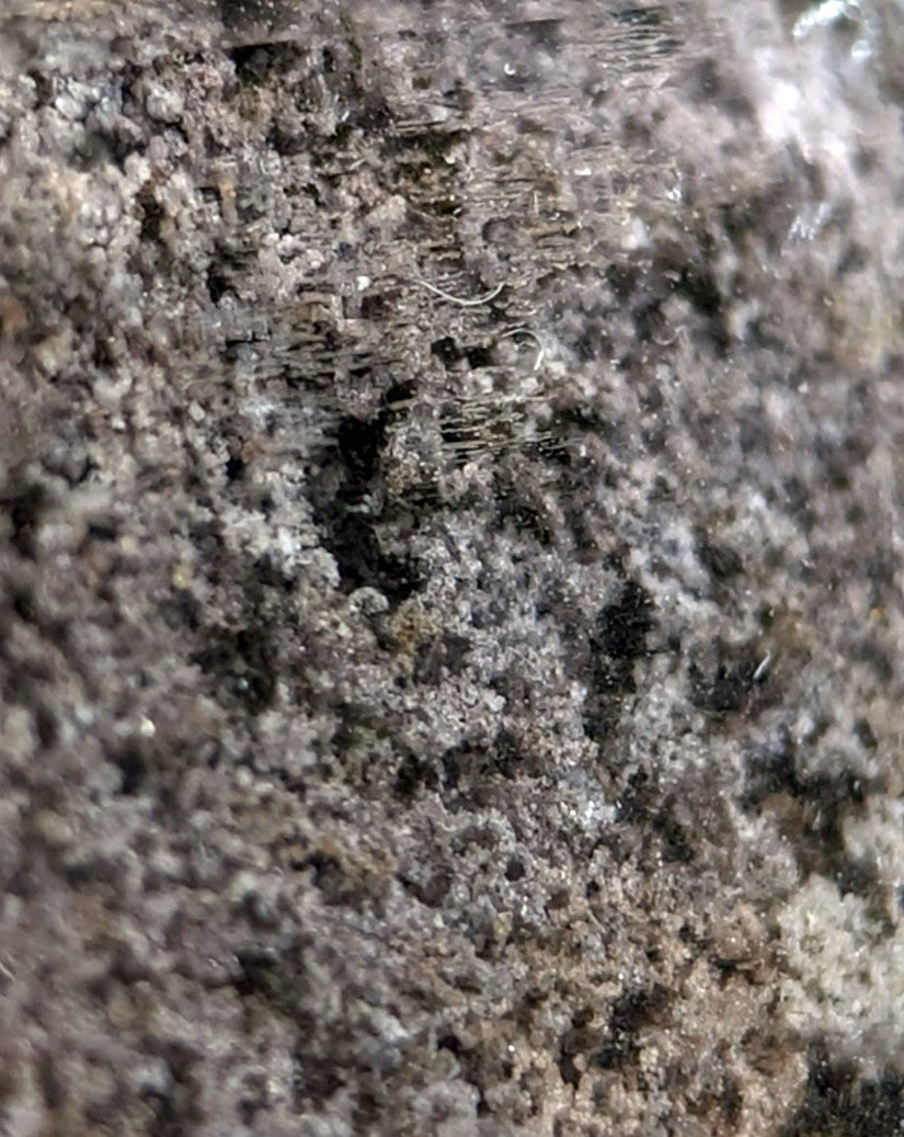 Unique phantom quartz with a textured dark gray and black granular surface mounted on custom wood from garland county arkansas