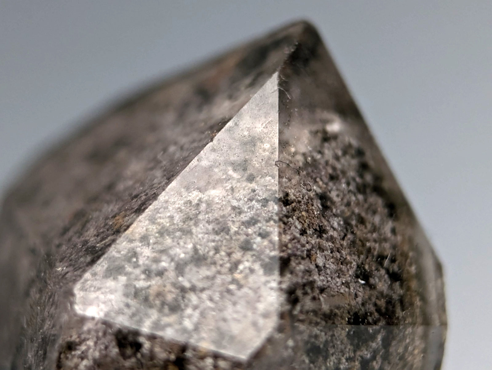 Unique phantom quartz with dark translucent faceted crystal and speckled surface on custom wood mount from Arkansas