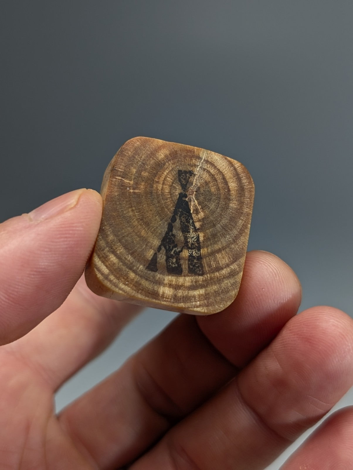 Unique phantom quartz wooden coaster with black a-frame tent silhouette engraved on natural wood grain mount