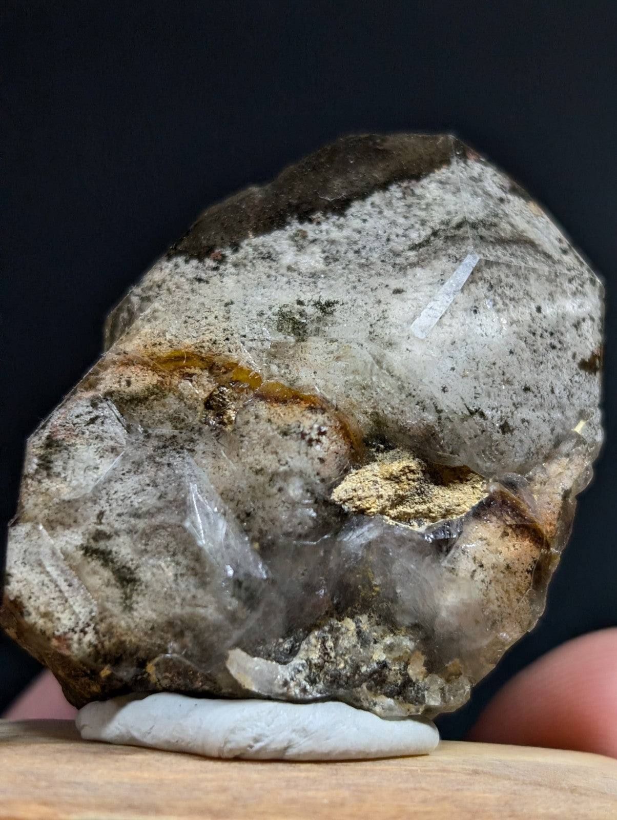 A rough, translucent quartz specimen with a grayish-white base and golden-yellow inclusions.
