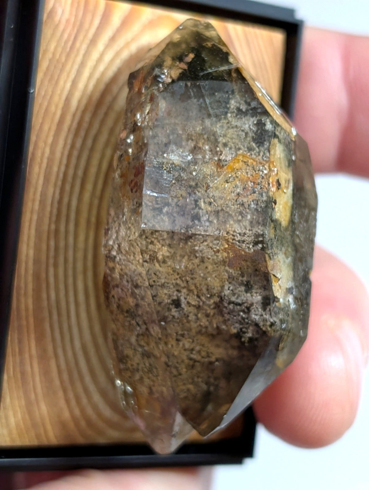 A translucent, multi-faceted citrine crystal with golden inclusions and a rough, natural surface.
