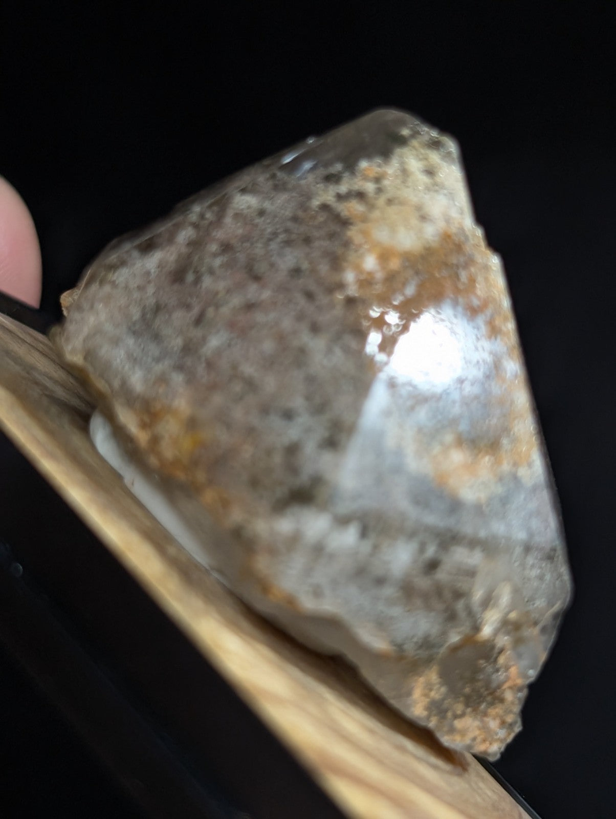 A translucent, faceted quartz crystal with a mix of clear and brownish-yellow mineral inclusions.