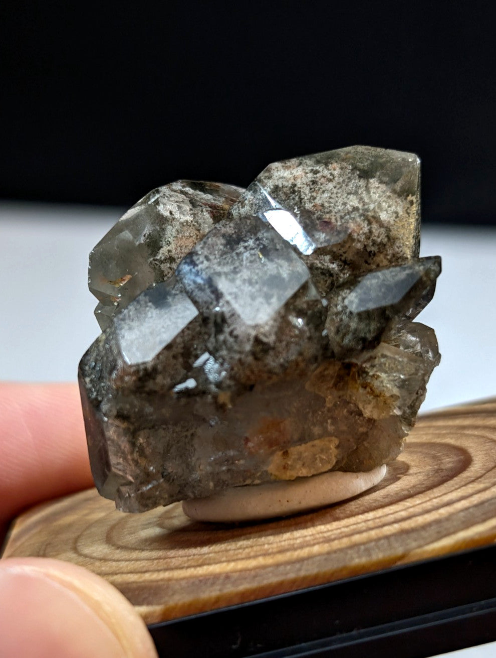 A translucent gray crystal cluster with sharp, faceted edges and subtle internal inclusions.