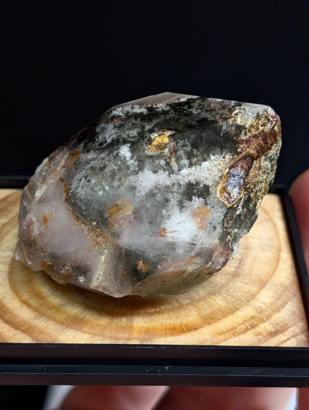 A translucent, irregularly shaped geode with a mix of gray, white, and earthy brown mineral inclusions.