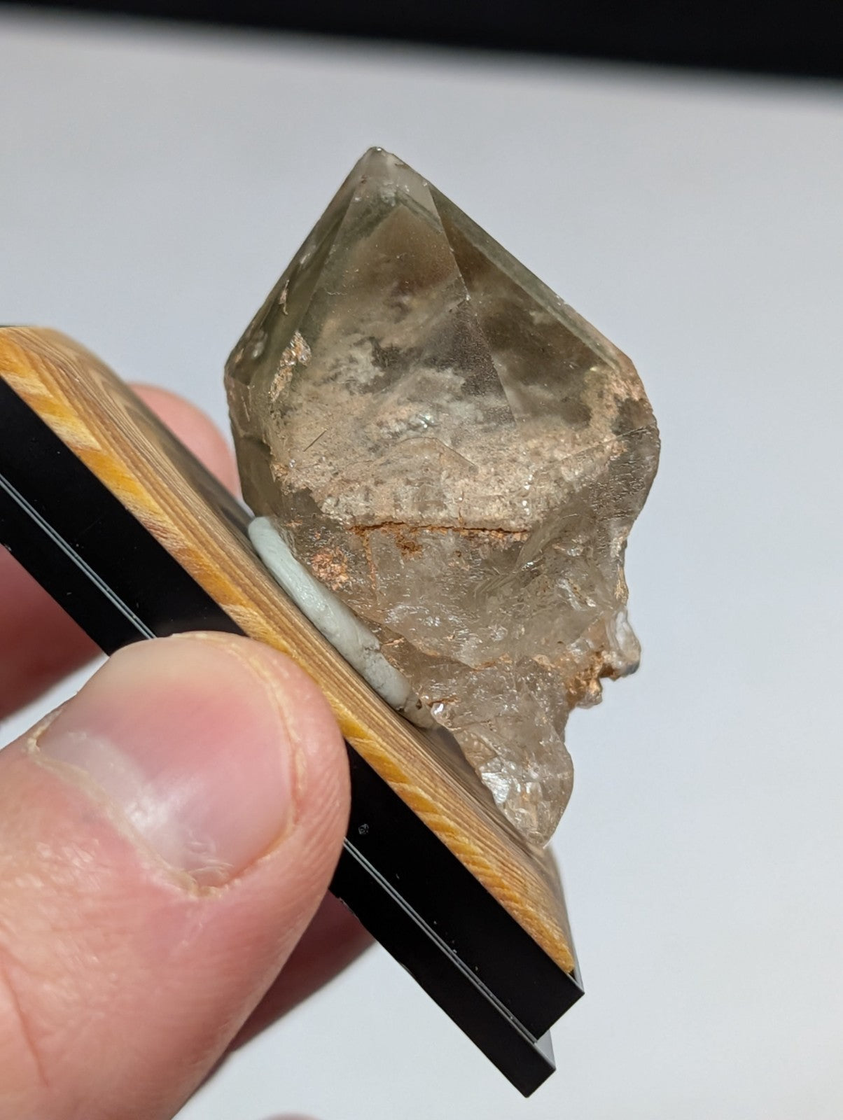 A translucent, light brown quartz crystal with a rough, natural surface and visible internal inclusions.