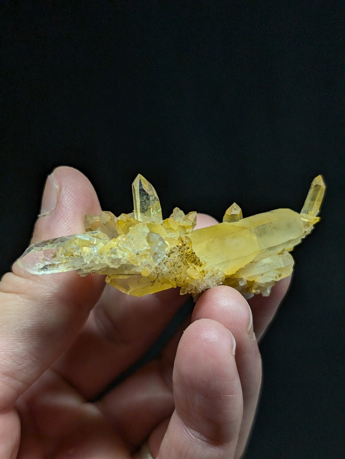 A translucent yellow crystal cluster with sharp, pointed facets and a slightly cloudy base.