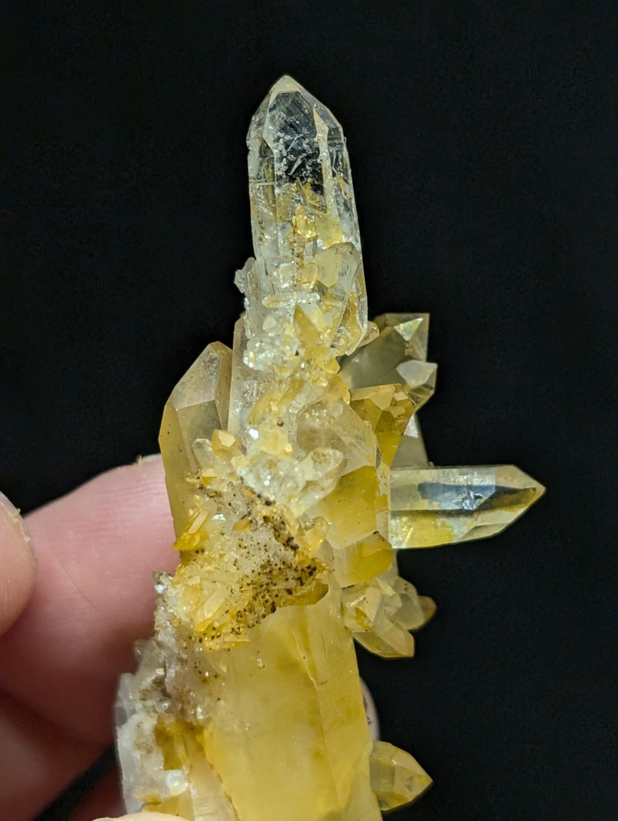 A translucent yellow crystal cluster with sharp, pointed facets and a mix of clear quartz formations.