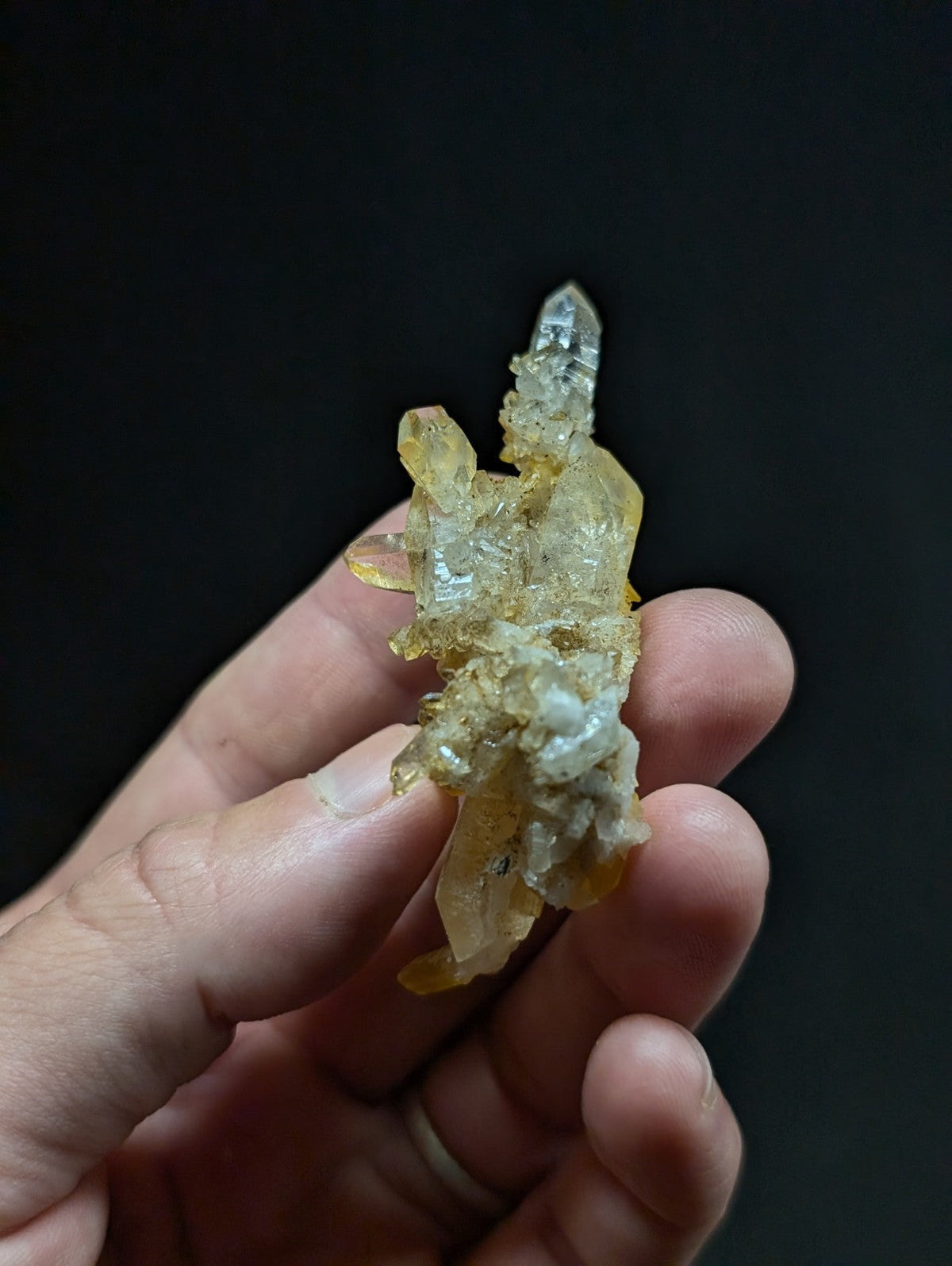 A translucent yellow and clear quartz crystal cluster with a rough, natural texture.