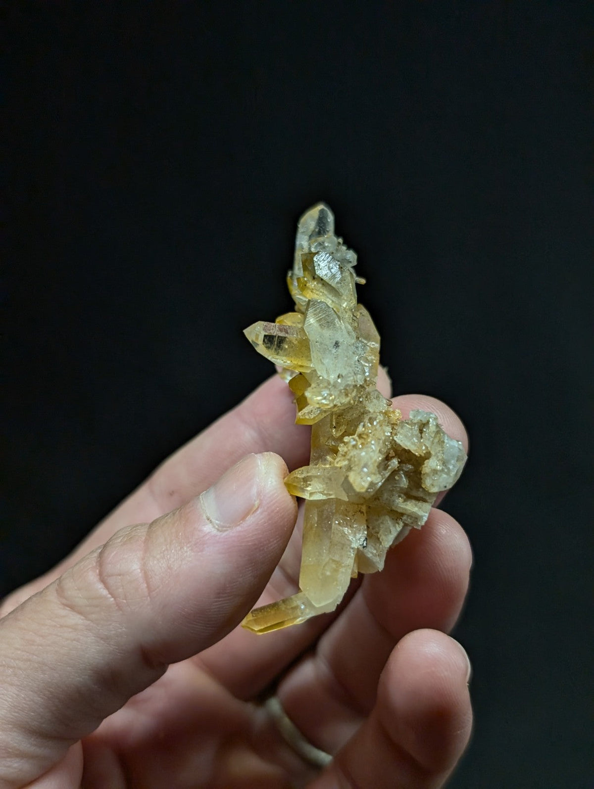 A translucent yellow crystal cluster with sharp, interlocking facets and a slightly cloudy texture.