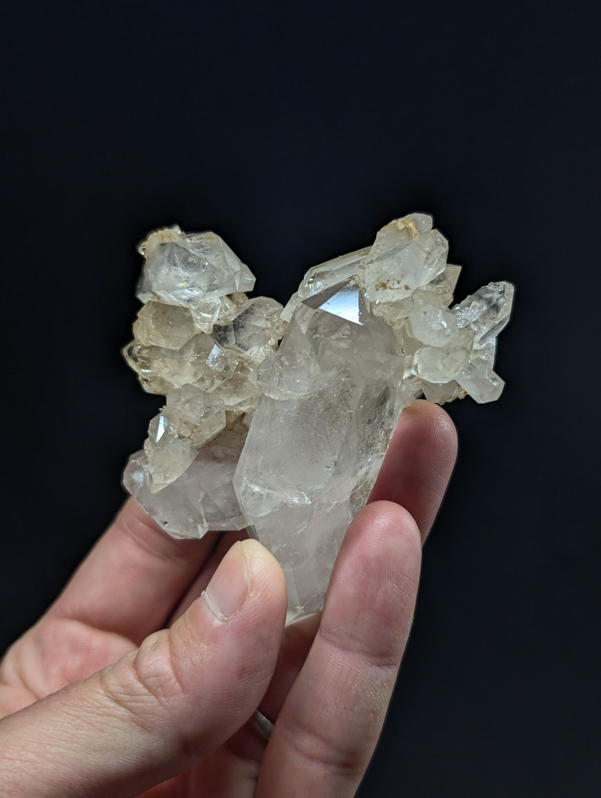 A translucent, clear quartz crystal cluster with a natural, jagged formation and subtle internal inclusions.