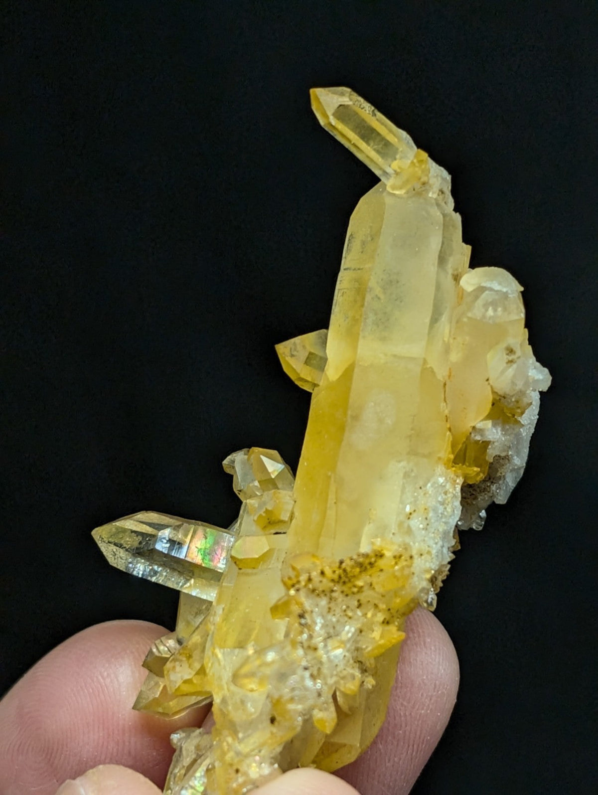 A translucent yellow crystal cluster with sharp, faceted points and a mix of clear quartz formations.