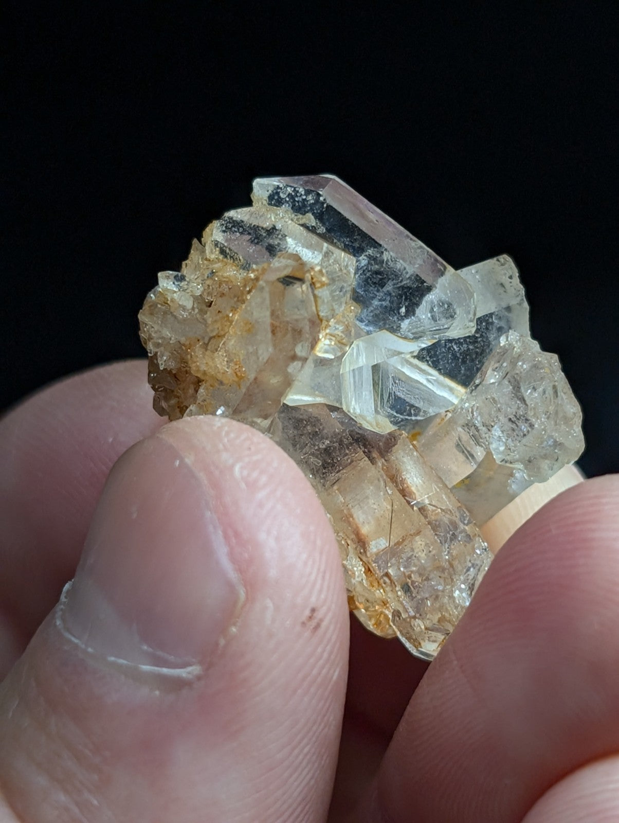 A translucent, crystalline mineral specimen with clear and golden-brown hues.