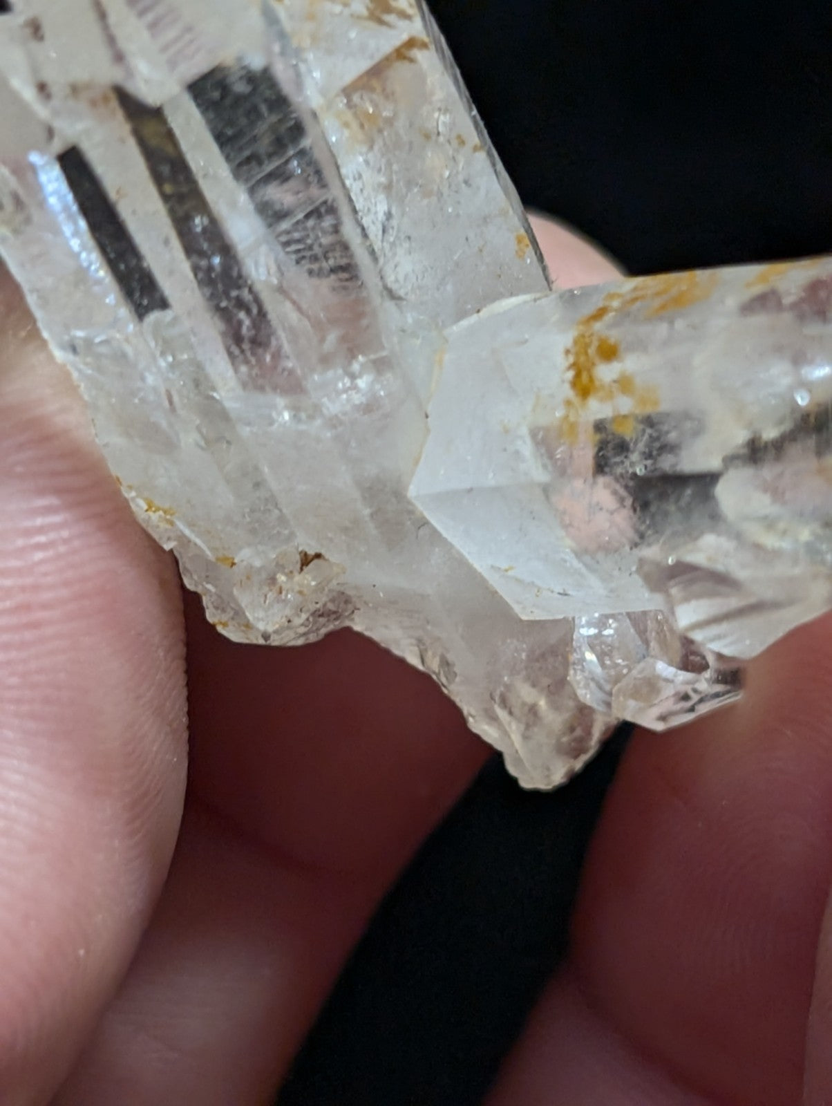 A translucent, clear quartz crystal cluster with natural inclusions and subtle golden-yellow mineral veins.
