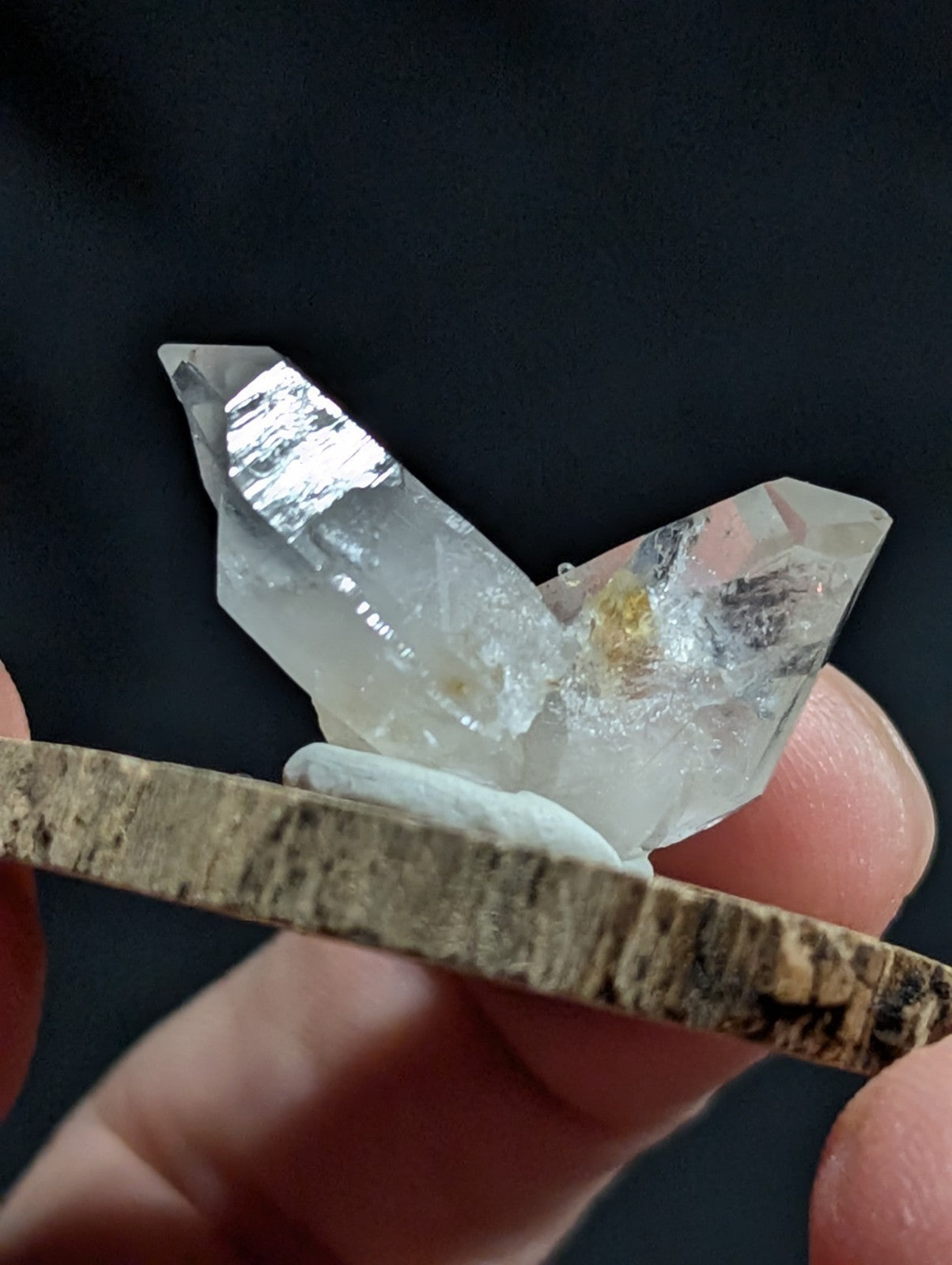 A clear, translucent quartz crystal cluster with sharp facets and subtle internal inclusions.