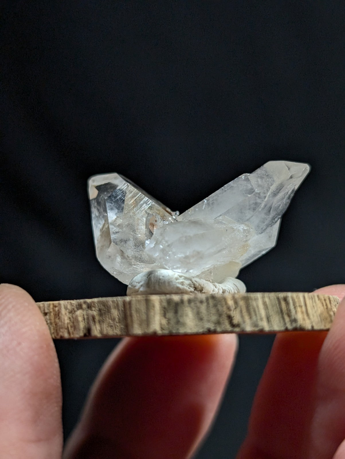 A clear, translucent quartz crystal cluster with sharp facets and natural inclusions.