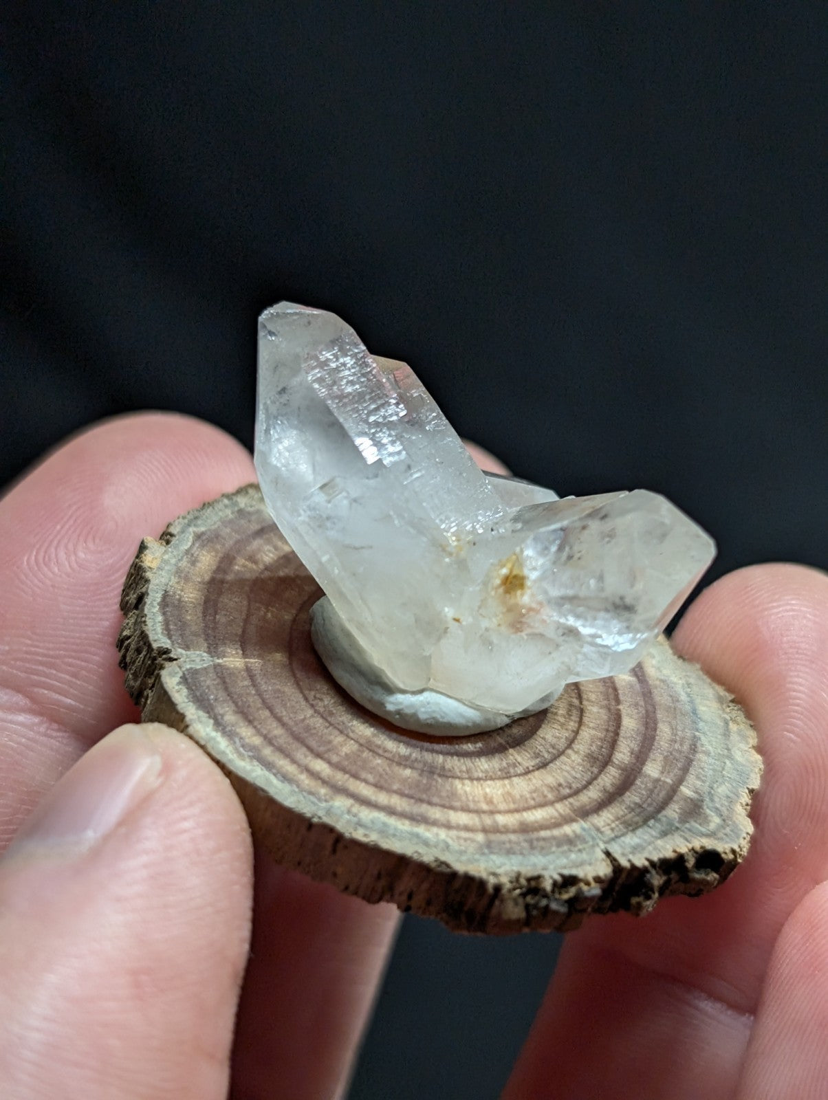 A translucent, clear quartz crystal cluster with subtle internal inclusions and a slightly rough, natural surface.