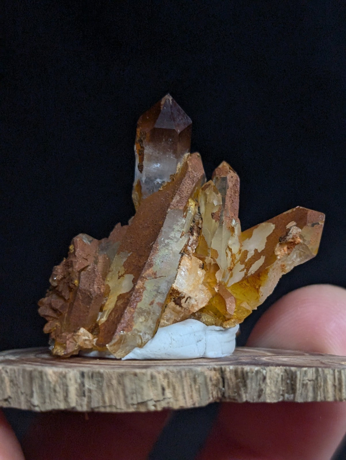 A cluster of golden-brown, translucent citrine crystals with sharp facets and a natural mineral matrix.