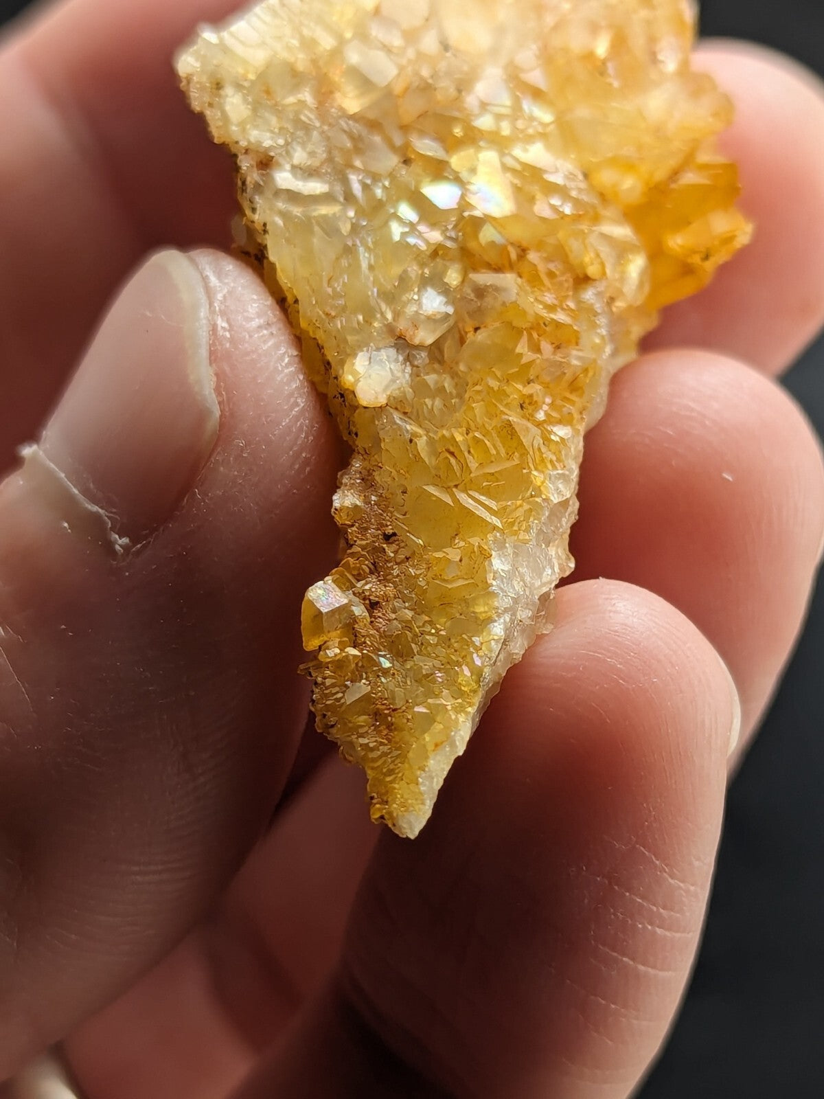A translucent golden-yellow crystal cluster with sharp, faceted points and a rough, natural texture.
